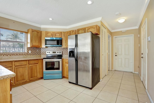 901 SW 15th St, Deerfield Beach, FL 33441 - kitchen with stainless steel appliances, light countertops, light tile patterned flooring, tasteful backsplash, and ornamental molding