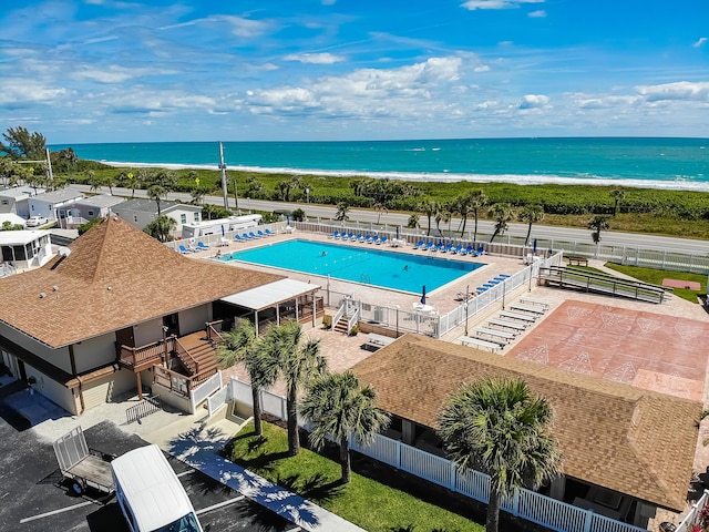 drone / aerial view with a beach view and a water view