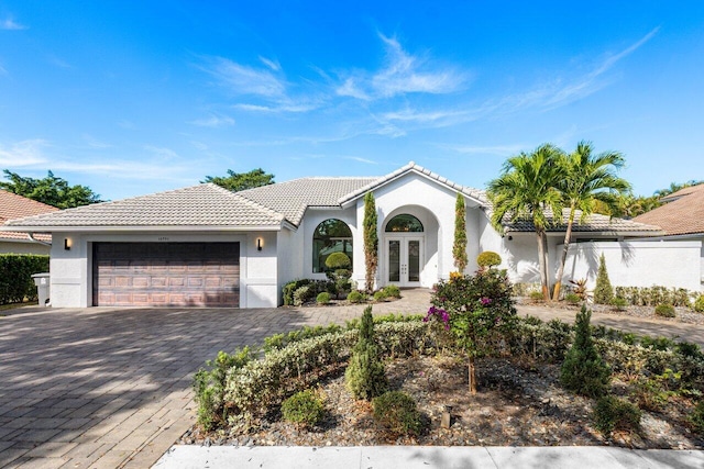 mediterranean / spanish-style home featuring french doors and a garage