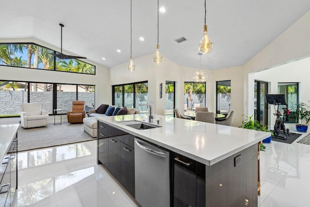 kitchen with a large island, sink, stainless steel dishwasher, decorative light fixtures, and light tile patterned floors