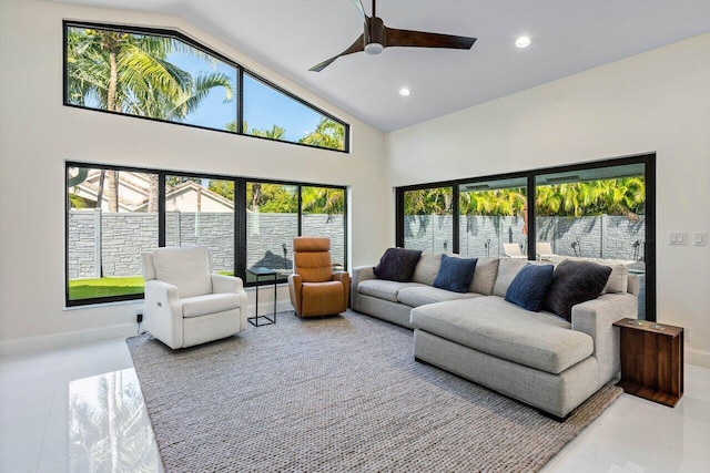 tiled living room featuring ceiling fan and high vaulted ceiling