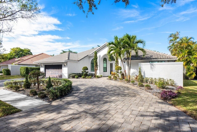 mediterranean / spanish home featuring a garage