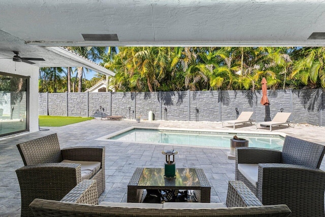 view of swimming pool featuring a patio area and ceiling fan