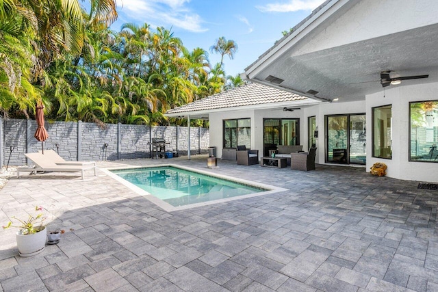 view of swimming pool featuring outdoor lounge area, ceiling fan, a patio, and grilling area