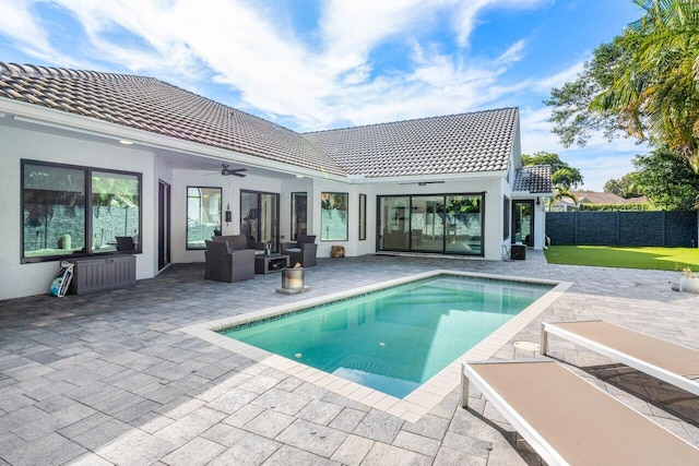 rear view of property with a fenced in pool, ceiling fan, a patio, and an outdoor hangout area