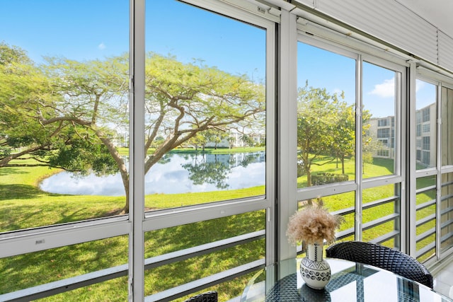 unfurnished sunroom with a wealth of natural light and a water view