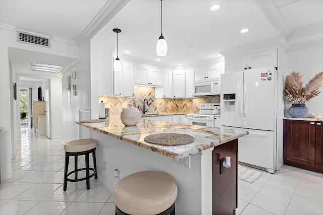 kitchen featuring light stone countertops, a breakfast bar, white appliances, decorative light fixtures, and white cabinetry