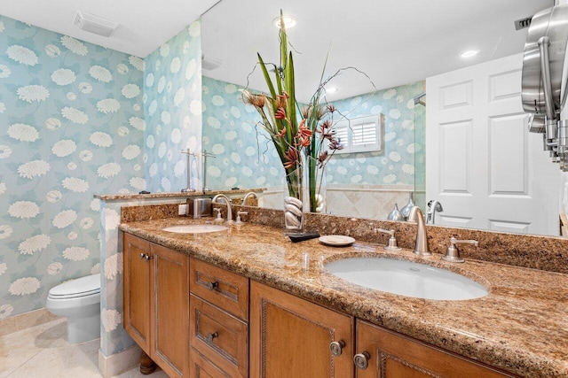 bathroom featuring tile patterned flooring, vanity, and toilet