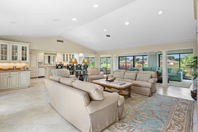 living room with lofted ceiling, light tile patterned floors, and ornate columns