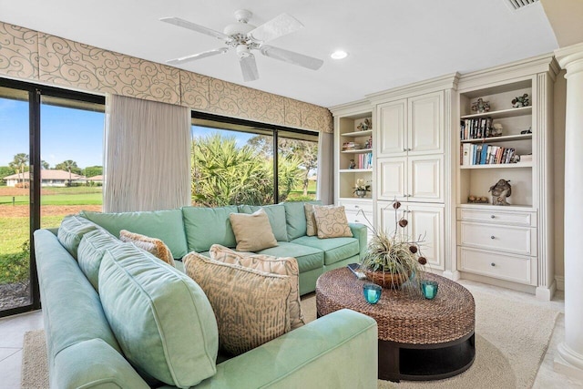 living room with built in features and ceiling fan