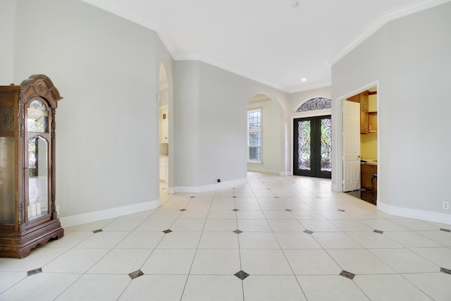 tiled foyer with crown molding and french doors