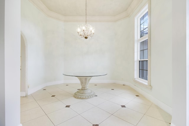 unfurnished dining area featuring crown molding, light tile patterned floors, and a chandelier