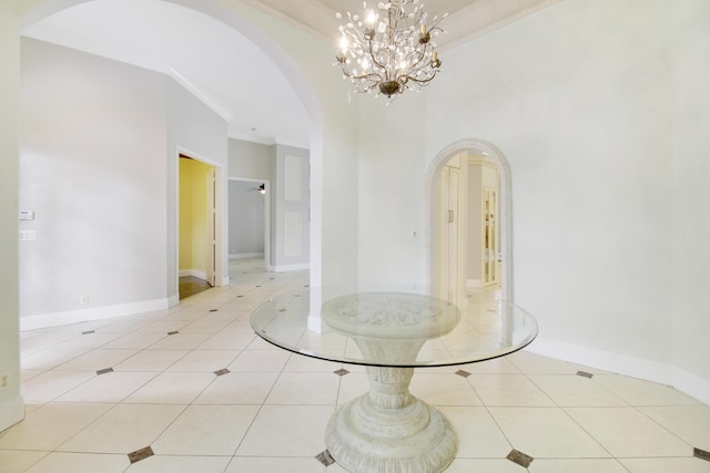 unfurnished room featuring an inviting chandelier, light tile patterned floors, and ornamental molding