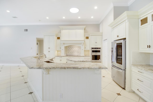 kitchen featuring decorative backsplash, appliances with stainless steel finishes, light stone countertops, light tile patterned floors, and a large island