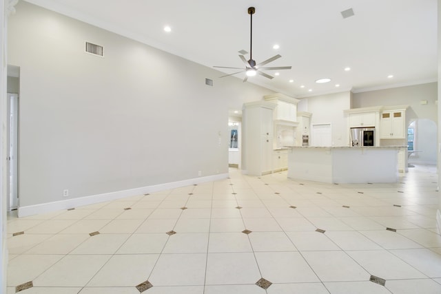 unfurnished living room with crown molding, light tile patterned flooring, a high ceiling, and ceiling fan