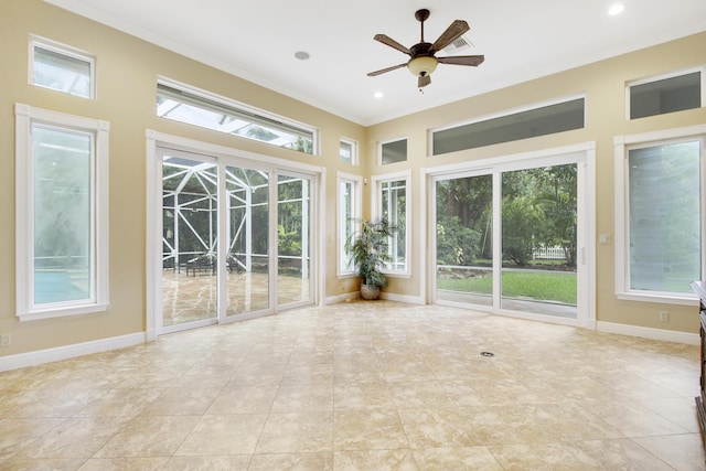 unfurnished sunroom featuring ceiling fan