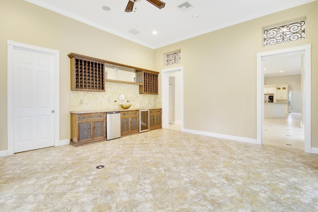 kitchen with backsplash, wine cooler, ceiling fan, and ornamental molding