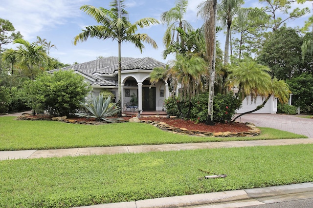 mediterranean / spanish-style home with a front yard