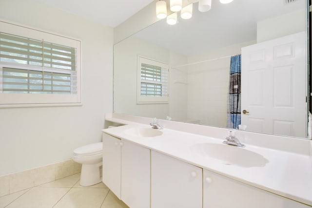 bathroom featuring tile patterned floors, vanity, a shower with shower curtain, and toilet