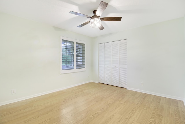 unfurnished bedroom with ceiling fan, light wood-type flooring, and a closet