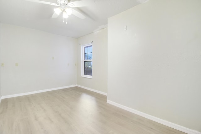 empty room featuring light hardwood / wood-style flooring and ceiling fan