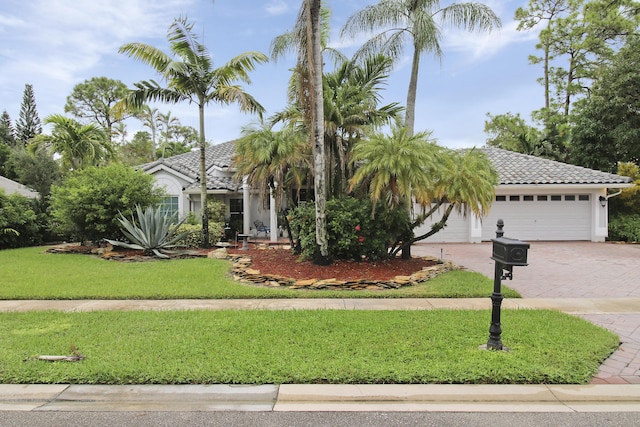 view of front of home with a garage and a front yard