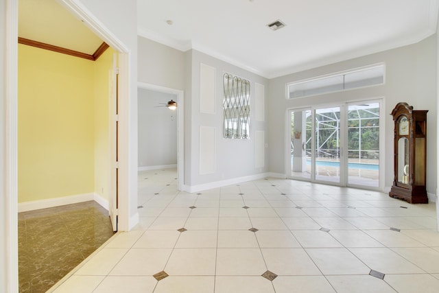 tiled spare room featuring ceiling fan and ornamental molding