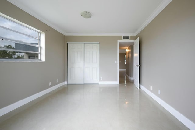 unfurnished bedroom featuring ornamental molding and a closet