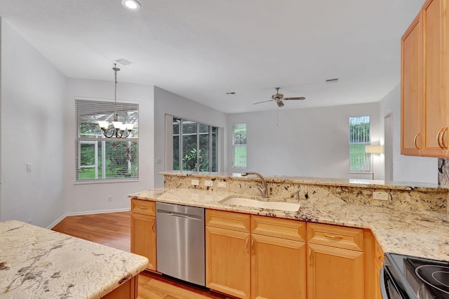 kitchen featuring pendant lighting, ceiling fan with notable chandelier, sink, stainless steel dishwasher, and light hardwood / wood-style floors