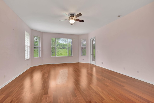 empty room featuring wood-type flooring and ceiling fan