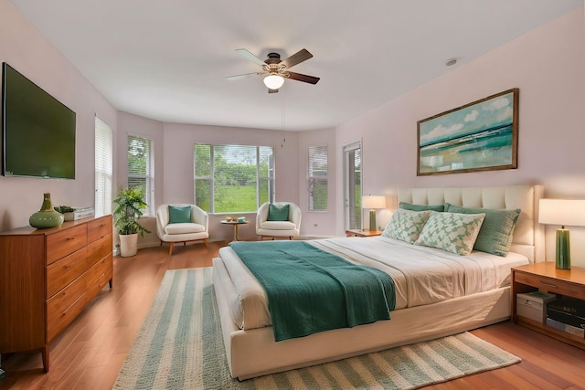 bedroom with ceiling fan and light hardwood / wood-style floors