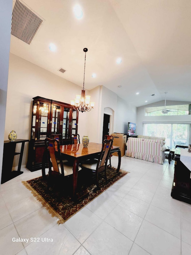 dining room featuring light tile patterned flooring, lofted ceiling, and a notable chandelier