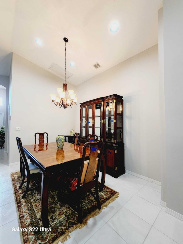 tiled dining space featuring an inviting chandelier