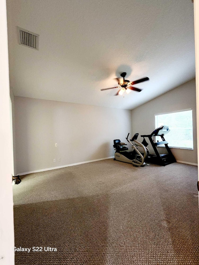 workout area with carpet, a textured ceiling, and ceiling fan