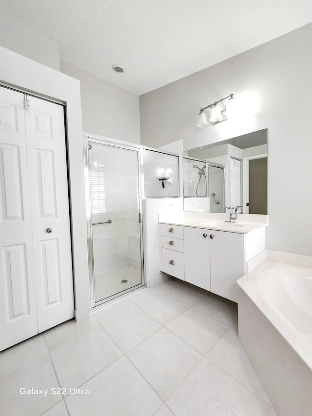 bathroom featuring vanity, independent shower and bath, and tile patterned flooring