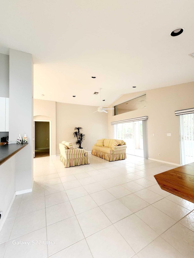 unfurnished living room featuring light tile patterned floors and vaulted ceiling