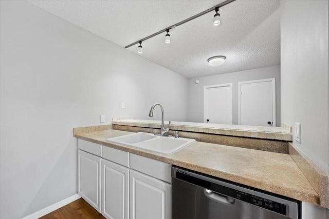 kitchen with sink, dark hardwood / wood-style flooring, stainless steel dishwasher, a textured ceiling, and white cabinets