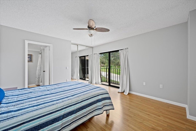 bedroom with ceiling fan, a textured ceiling, access to outside, and light hardwood / wood-style flooring