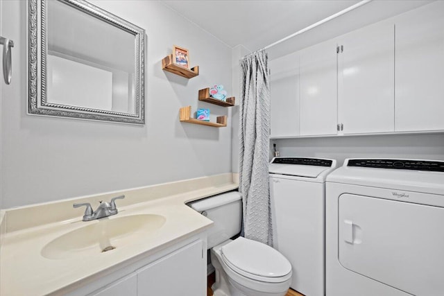 bathroom with a shower with shower curtain, independent washer and dryer, vanity, and toilet