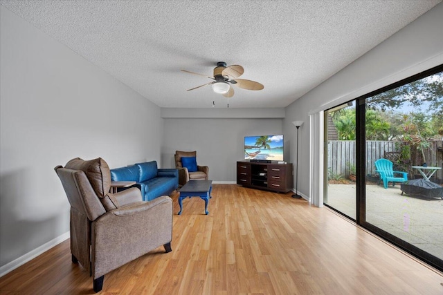 sitting room featuring a textured ceiling, light hardwood / wood-style floors, and ceiling fan