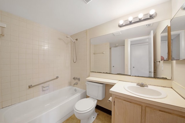 full bathroom featuring toilet, tiled shower / bath, and vanity