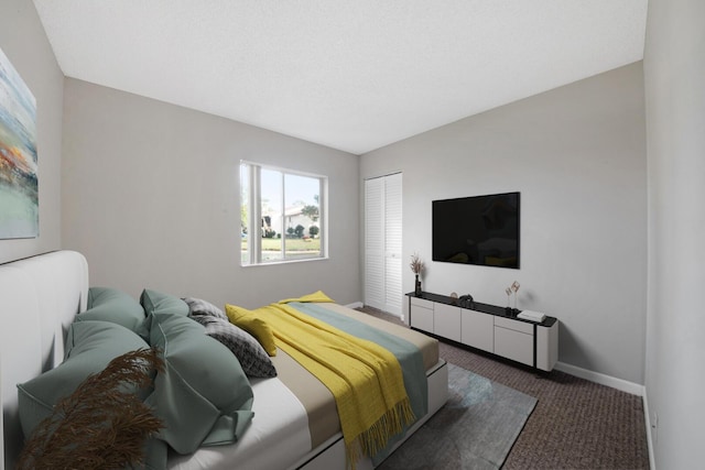 bedroom with a closet and dark colored carpet