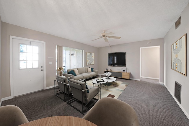 carpeted living room featuring a textured ceiling and ceiling fan