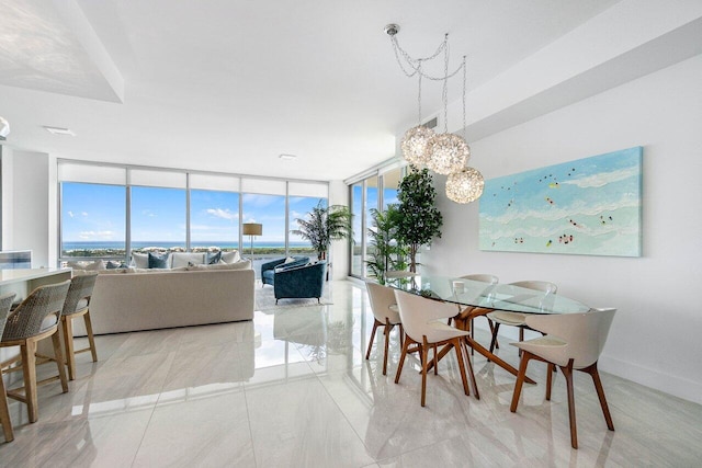 tiled dining space featuring a chandelier and floor to ceiling windows