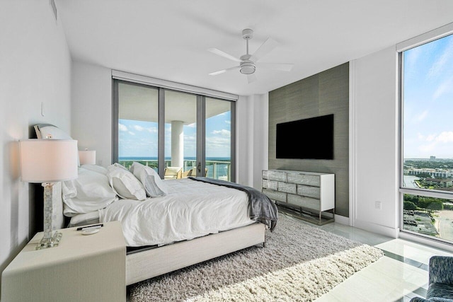 tiled bedroom with access to outside, floor to ceiling windows, and ceiling fan