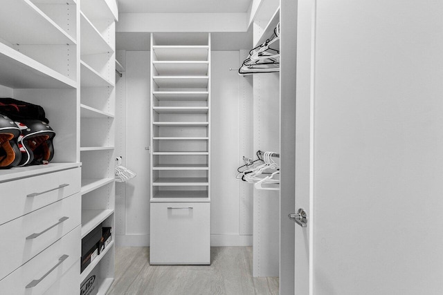 walk in closet featuring light hardwood / wood-style floors