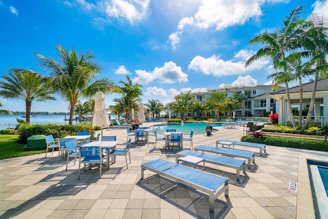 view of patio / terrace with a water view and a community pool