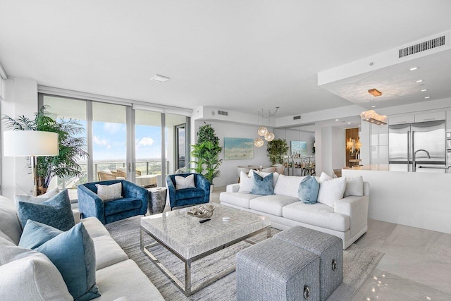 living room with expansive windows and sink