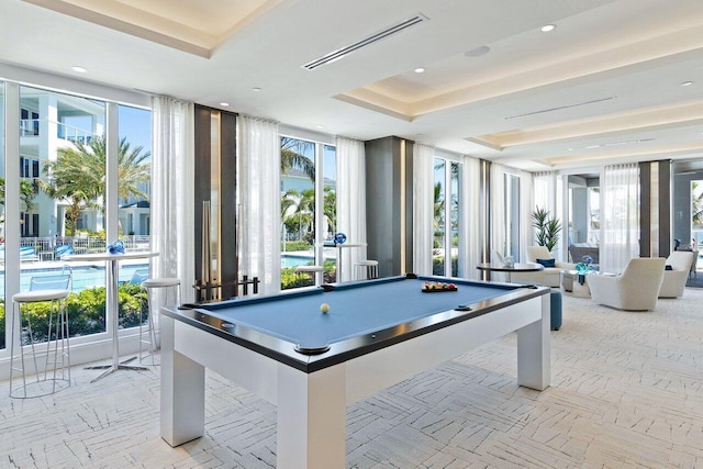 playroom with a healthy amount of sunlight, pool table, and a tray ceiling