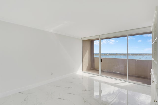 empty room featuring floor to ceiling windows, a water view, and ornamental molding